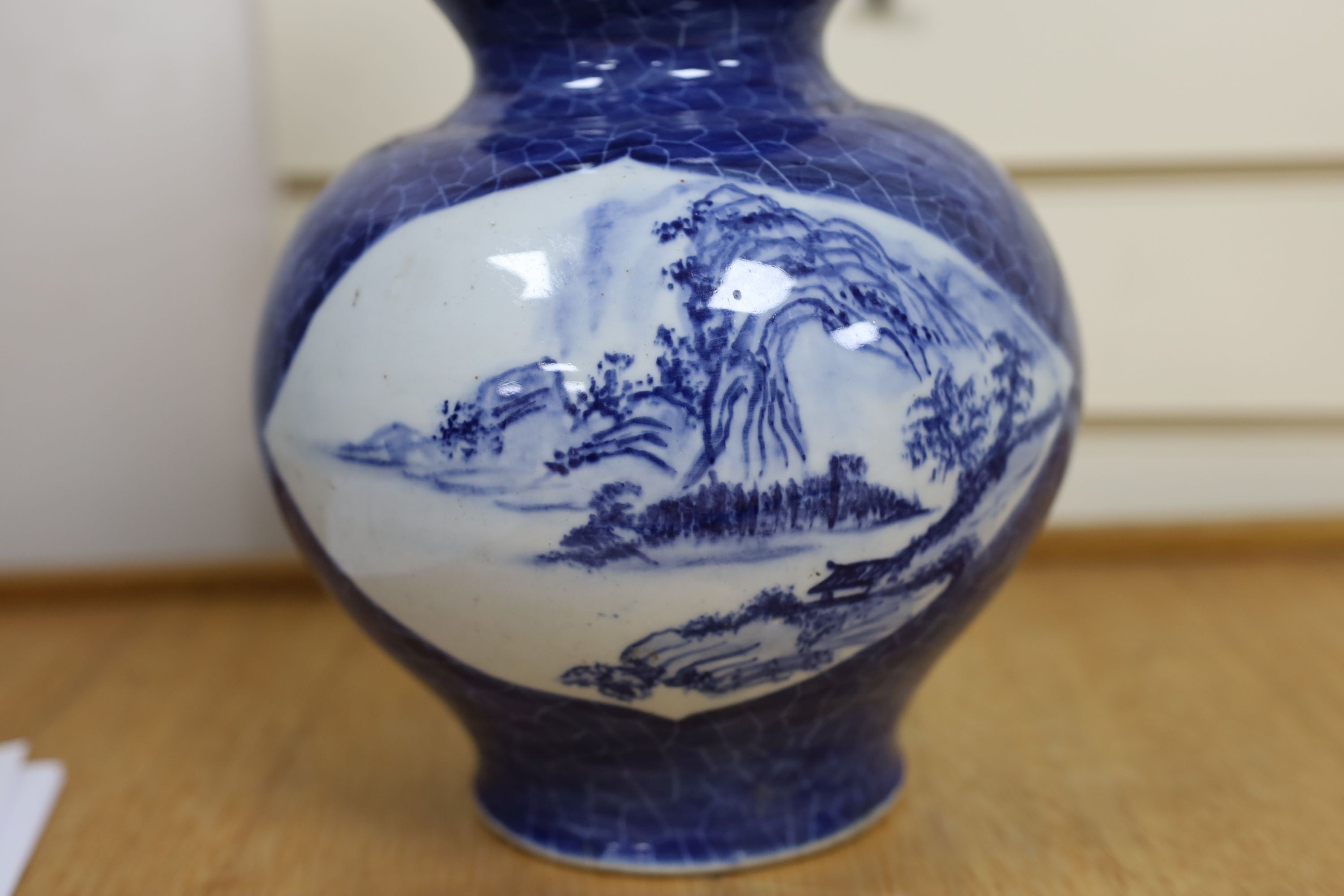 A Chinese blue and white gourd vase with landscape decoration, a similar blue and white sleeve vase and a Japanese Kutani vase